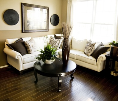 a formal living room with wood flooring in a dark finish