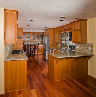 a kitchen with wood flooring in a natural finish
